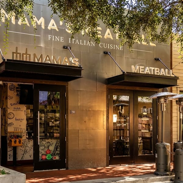 Mama's Meatball restaurant exterior with "Fine Italian Cuisine" sign, two doors, and outdoor heaters.