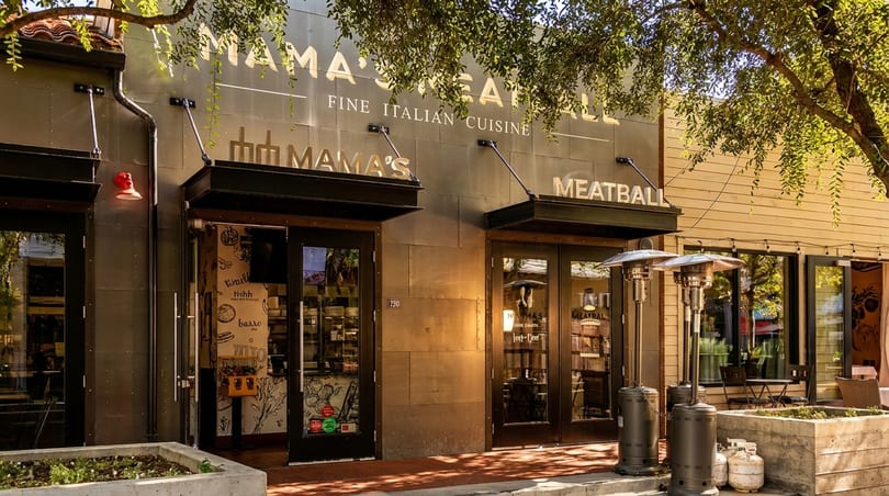 Mama's Meatball restaurant exterior with "Fine Italian Cuisine" sign, two doors, and outdoor heaters.